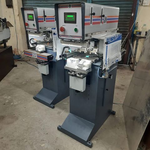 Two GI-90 pad printing machines side by side, one with a two colour shuttle