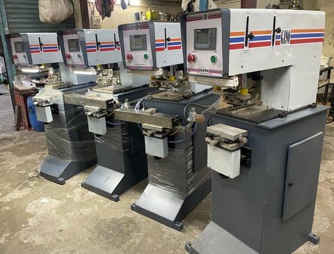 Four GI-90 pad printing machines lined up on the shop floor